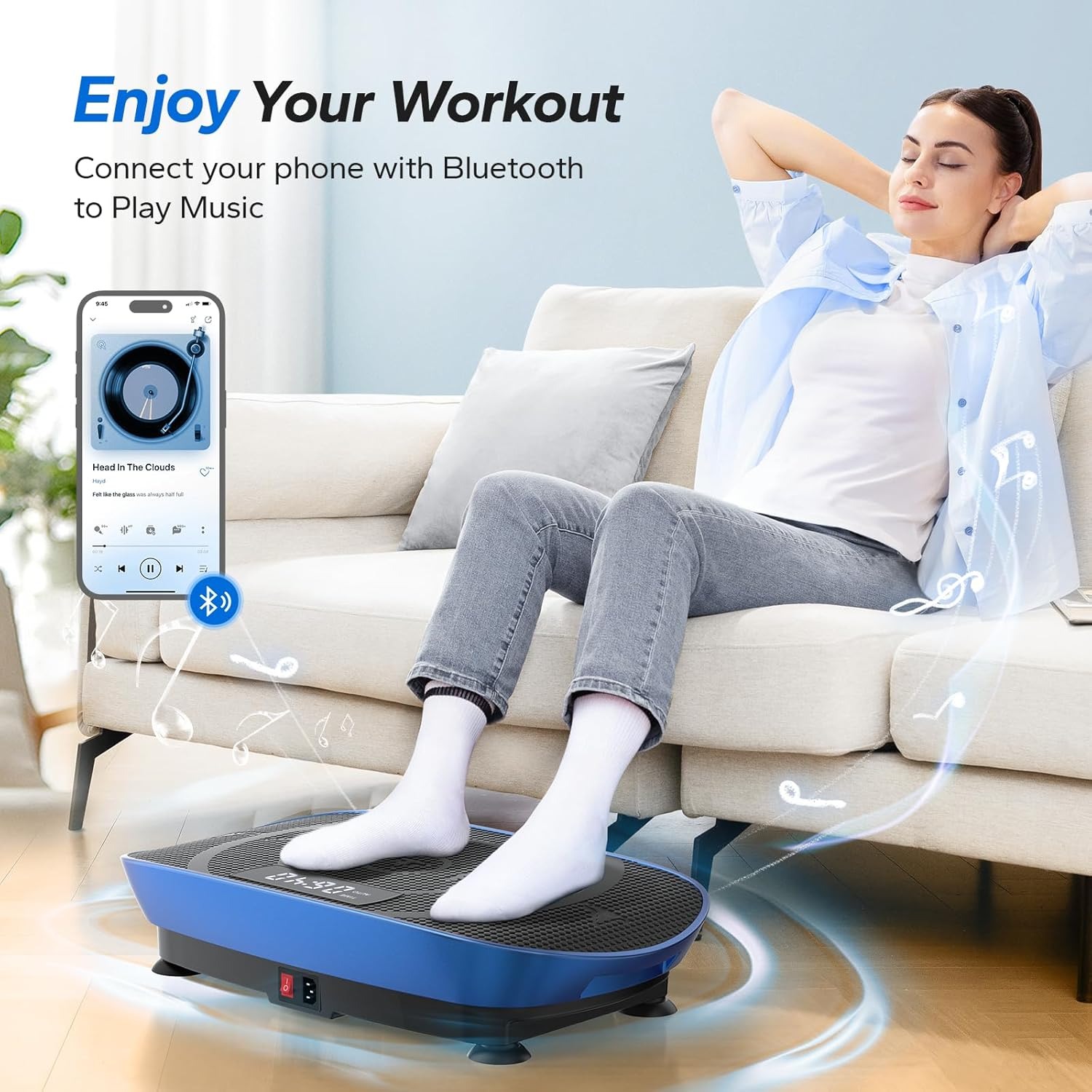 Woman using a vibration plate while seated on a sofa