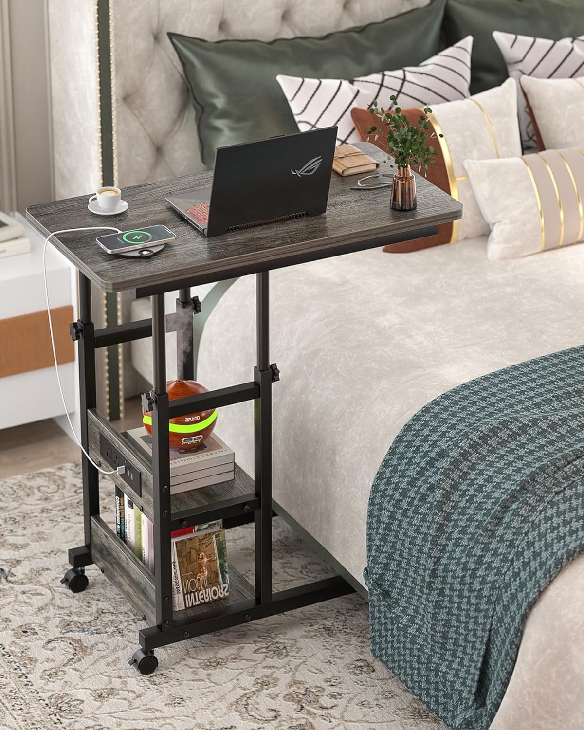 Rolling side table positioned beside a bed