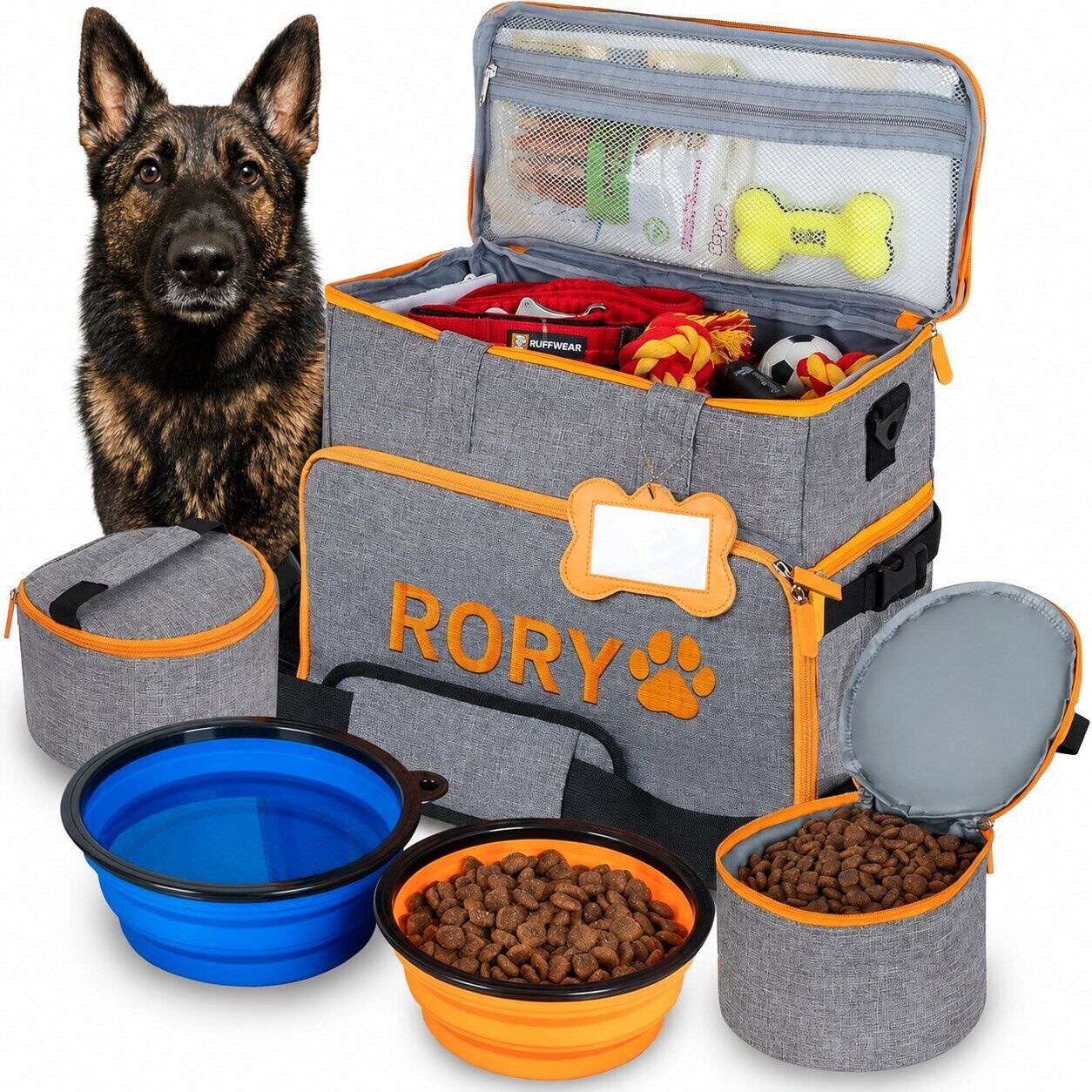 Customized gray and orange dog travel bag embroidered with Rory’s name and shown with bowls, food containers, toys, and Rory